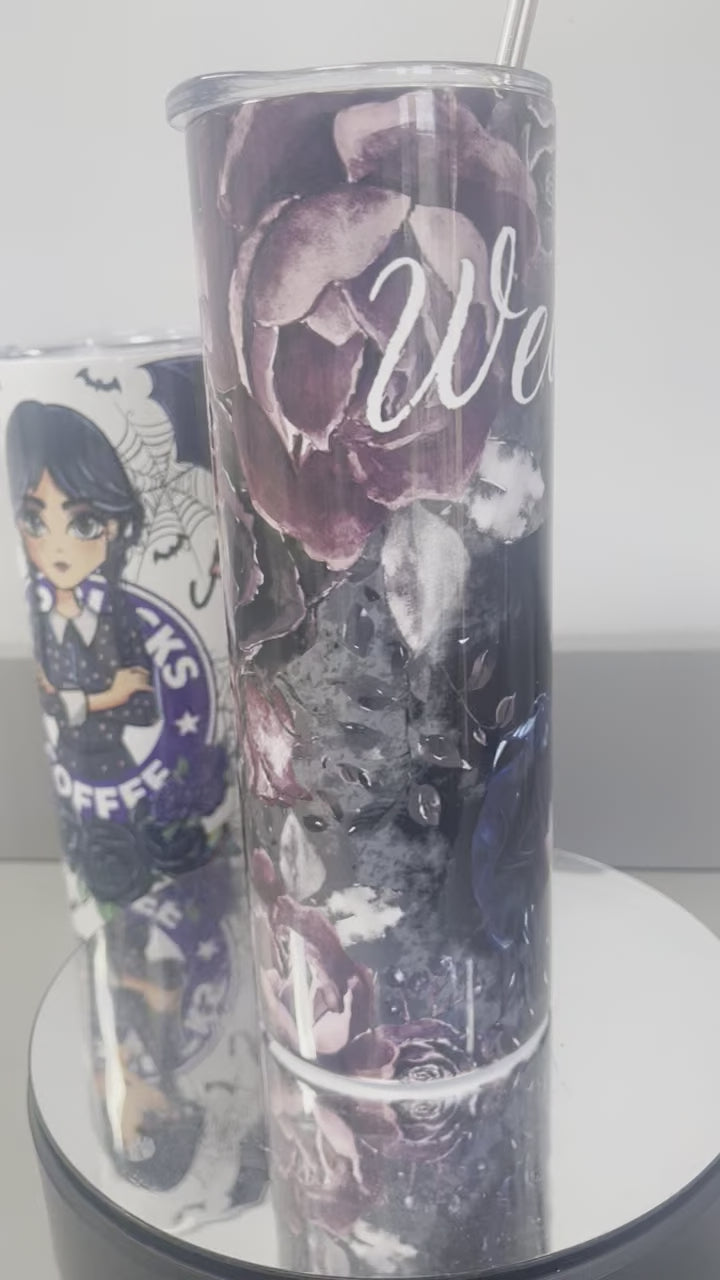 video of Wednesday Tumbler featuring the charachter in the middle, the name above with pink flowers and a black background